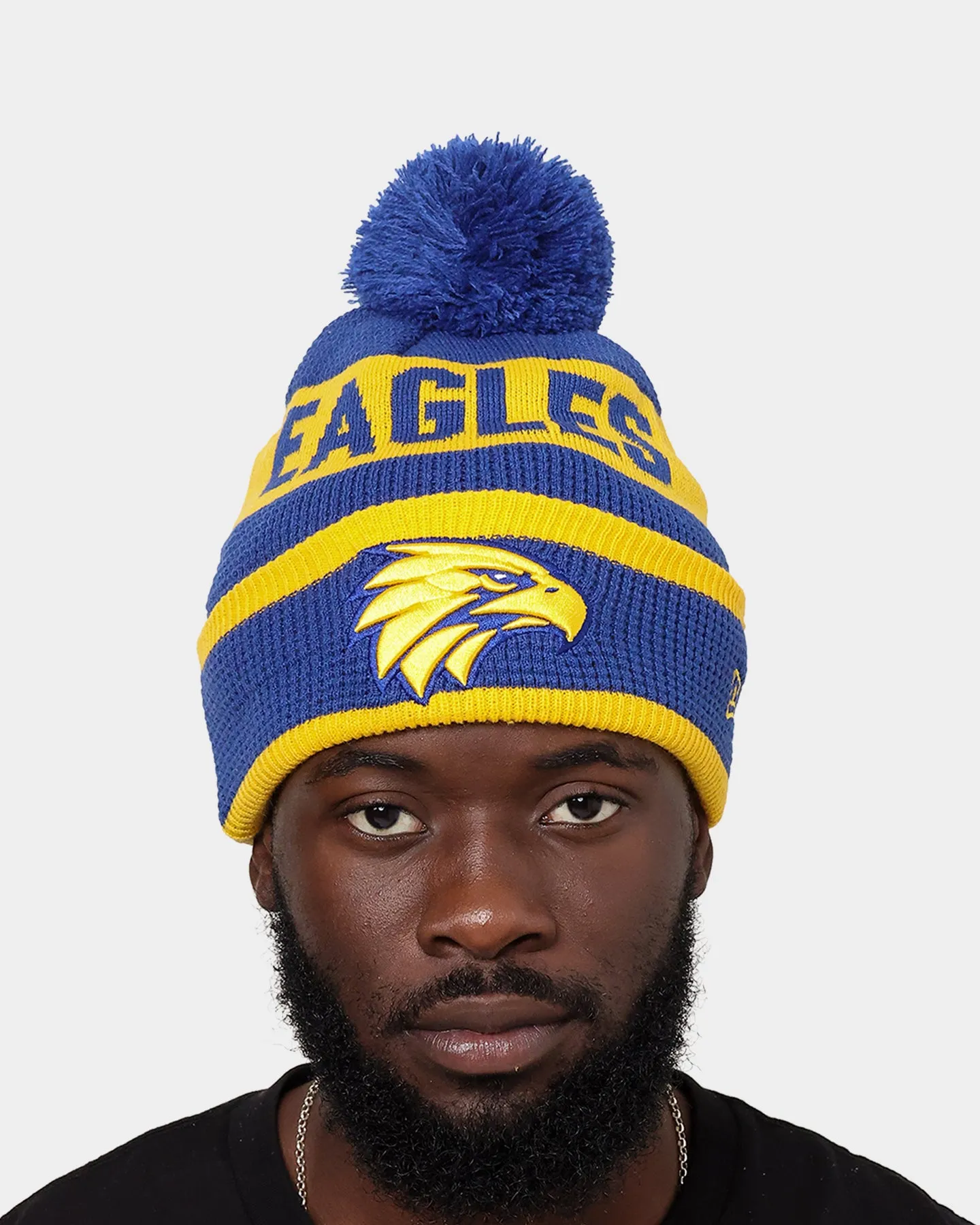 New Era West Coast Eagles AFL Opening Bounce 2022 Pom Waffle Wordmark Beanie Medium Blue/Yellow