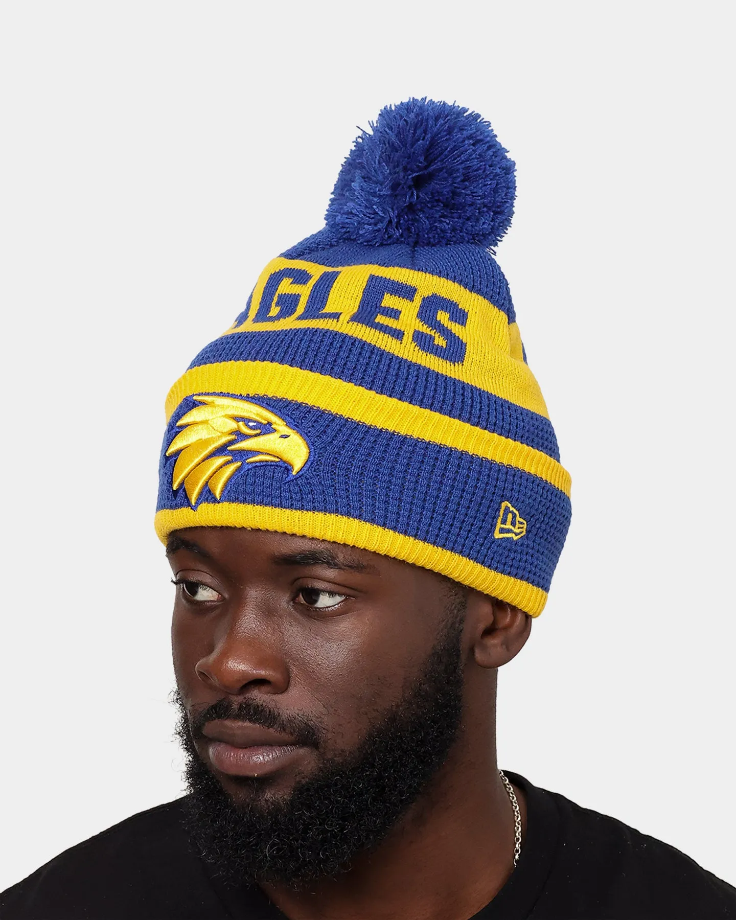 New Era West Coast Eagles AFL Opening Bounce 2022 Pom Waffle Wordmark Beanie Medium Blue/Yellow